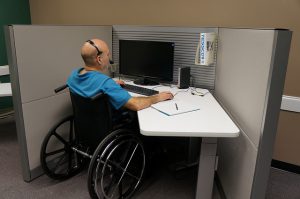 man in wheelchair working at call center